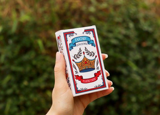 Hand holding a deck of cards with a fantasy design 